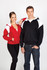 A red and black shoulder contrast zip hoodie with a white design, worn by a woman and a man. Both are standing together.