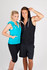 A sleeveless zip hoodie in turquoise on a woman and black on a man, both with hoods up, styled for a promotional shoot.