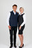 A navy blue men's soft shell vest and a black women's soft shell vest, both with a logo, displayed on models.