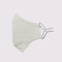 A white, adjustable cotton face mask with toggle features is displayed. It has a simple, minimalistic design.