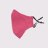 A pink adult face mask with a three-layer design and adjustable toggle straps, featuring a logo.