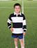 A kid's rugby polo top in navy and white stripes, featuring a collared neckline, displayed on a boy standing on a grassy field.