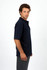 A navy blue men's 100% cotton jersey polo shirt displayed on a model, featuring a collar and short sleeves.
