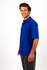 A man smiling while wearing a blue regular pique knit polo shirt, paired with grey pants.