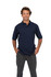 A navy blue men's cotton pique knit polo shirt displayed on a smiling man wearing grey trousers. The shirt features a logo.