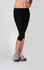 Black women's cotton spandex 3/4 leggings, fitted style, paired with athletic shoes.