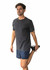 A model wearing a men's unisex stone wash t-shirt in black, paired with shorts, demonstrating a stretching pose.