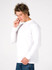 A white long sleeve T-shirt displayed on a model who is holding a phone, with a plain background.