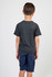 A boy wearing a dark grey heather T-shirt, standing with his back to the camera, paired with navy shorts.