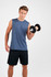 A man holding a dumbbell wears a navy blue sleeveless tee and black shorts. The shirt has a logo.