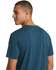A unisex earth care T-shirt in dark blue, featuring a logo, viewed from the back.