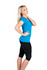 A woman in a blue raw cotton wave T-shirt poses sideways, wearing black leggings. The shirt has a logo.