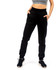 Brushed fleece track pants in black, featuring a fitted design and side pockets, styled with a cropped top and sneakers.