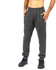 Grey brushed fleece track pants with an elastic waistband and side pockets, modelled by a person.