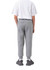 Grey three-layer cotton track pants with a tapered fit, featuring an elastic waistband and ribbed cuffs.