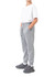 Grey three-layer cotton track pants with side pockets and a drawstring waist, paired with a white T-shirt and sneakers.