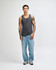 A unisex fine jersey tank in grey, worn with black loose-fitting pants and white sneakers. The tank features a logo.