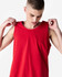 A red unisex fine jersey tank top with a relaxed fit and logo. Model is adjusting the straps.