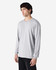 A light grey long sleeve t-shirt worn by a male model, featuring a simple design and a logo.