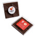 A chocolate square in a clear PVC stand-up box, featuring a textured brown chocolate surface and logos on the packaging.