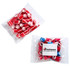 A clear bag containing red and blue rock candy pieces, with a logo on the packaging.