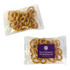 A clear plastic packet containing small, golden-brown pretzels, featuring a logo on the front.