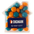 A clear acrylic house-shaped container filled with orange and teal chewy fruit candies. Features a logo.