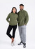 A green polar fleece half zip top is worn by a male and female model, paired with black leggings and grey sweatpants.
