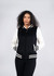 A black and white varsity jacket featuring a zip front and striped cuffs, designed for women and juniors.
