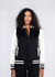 A black and white women's varsity jacket with a zip front, striped cuffs, and a logo on the chest.