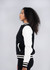 A black and white women's varsity jacket with a logo, shown from the side, featuring a soft shell design.