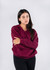 A unisex burgundy V-neck fleece jumper with a relaxed fit, featuring a simple design and no visible logos.