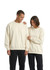 Two individuals wearing cream-coloured oversized crew neck fleece jumpers, with one featuring a logo.