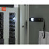A black mini grip slim LED flashlight attached to a metal surface, illuminating electrical circuit breakers.