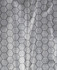 A close-up view of a hexagonal patterned fabric, featuring a black grid design over a light background.