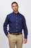 A men's long sleeve button-up shirt in navy blue, featuring a chest pocket and a logo. Paired with light-coloured trousers.