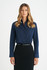 A ladies' long sleeve button-up shirt in navy blue, featuring a collar and button front, styled with a black belt.