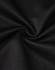 A close-up of black fabric, showcasing a smooth texture with a slight stretch, typical of polo shirt material.