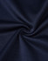 A close-up of dark navy fabric with a smooth texture, showcasing the sustainable poly/cotton blend.