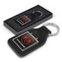 A square leather key ring featuring the Dodge logo, presented in a sleek black box with a cushioned interior.