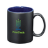 A black ceramic mug with a blue interior and a logo on the front, displayed in a simple design.