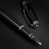 A black metal rollerball pen with a sleek design, featuring a clip and a logo on the cap.