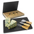 A slate cheese board set featuring a black board, three cheese knives with wooden handles, and blue cheese.