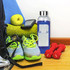 A drink bottle with a silicone cover, 500ml capacity, in blue, alongside fitness accessories and fresh fruit.