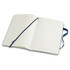 A large, soft cover notebook with blank lined pages and a blue ribbon bookmark inside.