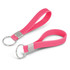 A pink silicone key ring with a smooth finish and a metal ring for attachment.