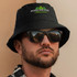 A black Oilskin Bucket Hat with a logo, paired with sunglasses, worn by a person with facial hair.