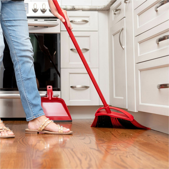 O-Cedar indoor broom sweeping debris from hardwood kitchen floor