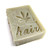Patchouli Shampoo Bar by Aquarian Bath, stamped with leaf and 'hair'