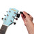 Tiger Guitar String Winder in use on an acoustic guitar tuning machine head for quick and efficient restringing.